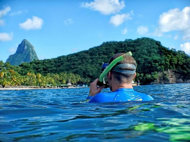 Snorkeler in the sea with Piton view Saint Lucia